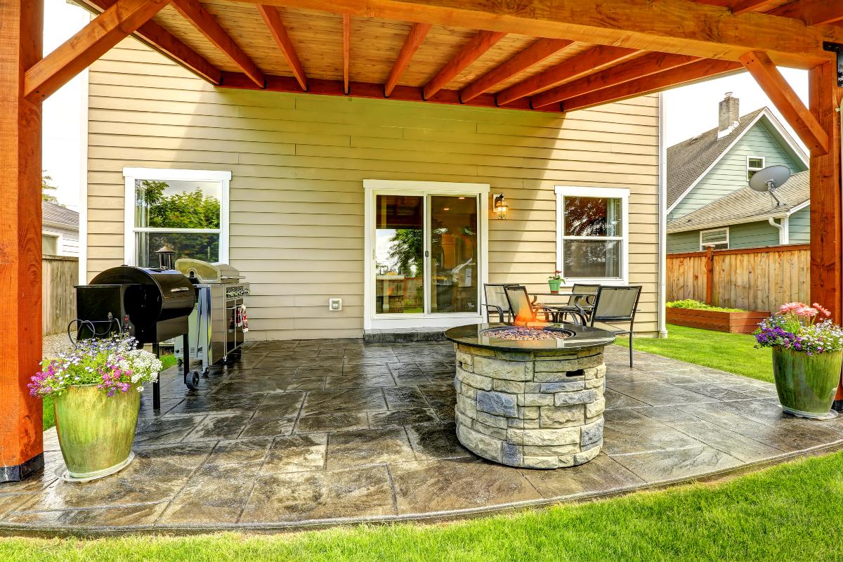 Patio area with tile floor and stone trimmed fire pit 1200x800px