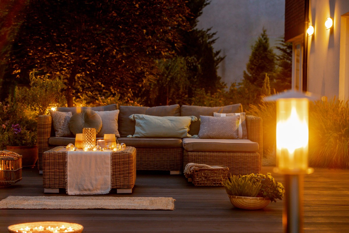 Summer night in the garden with trendy furniture, lights, lanterns and candles 1200x800px