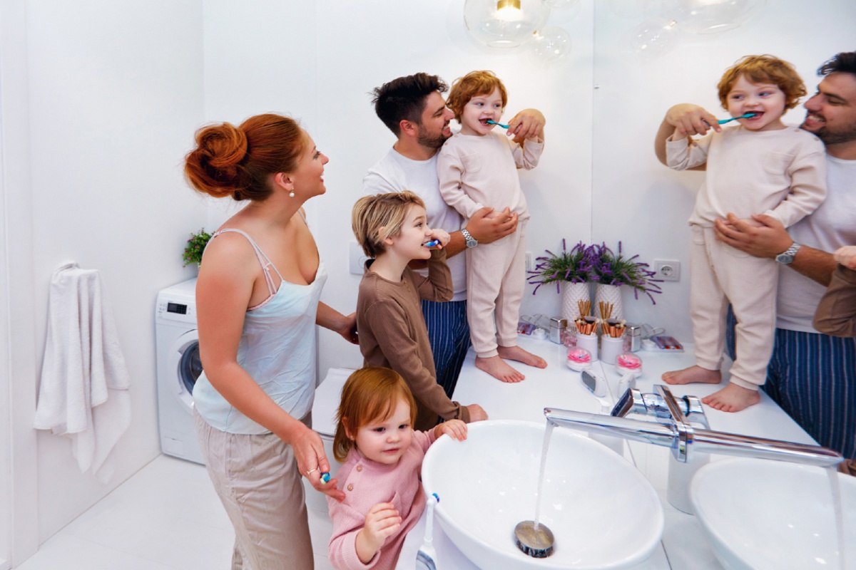 Happy family brushing teeth together in the bathroom in the morning 1200x800px