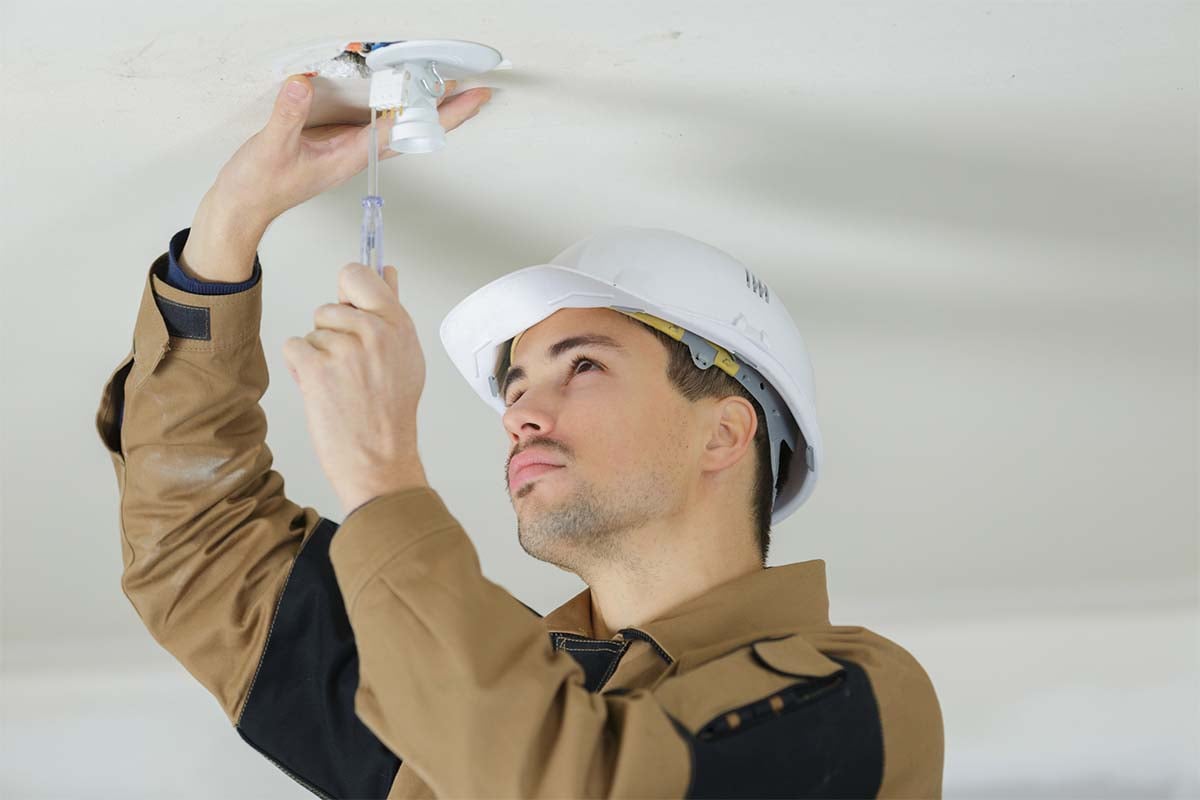 Man installing ceiling lights 1200x800